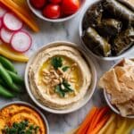 Hummus Board with Fresh Vegetables and Grape Leaves Recipe