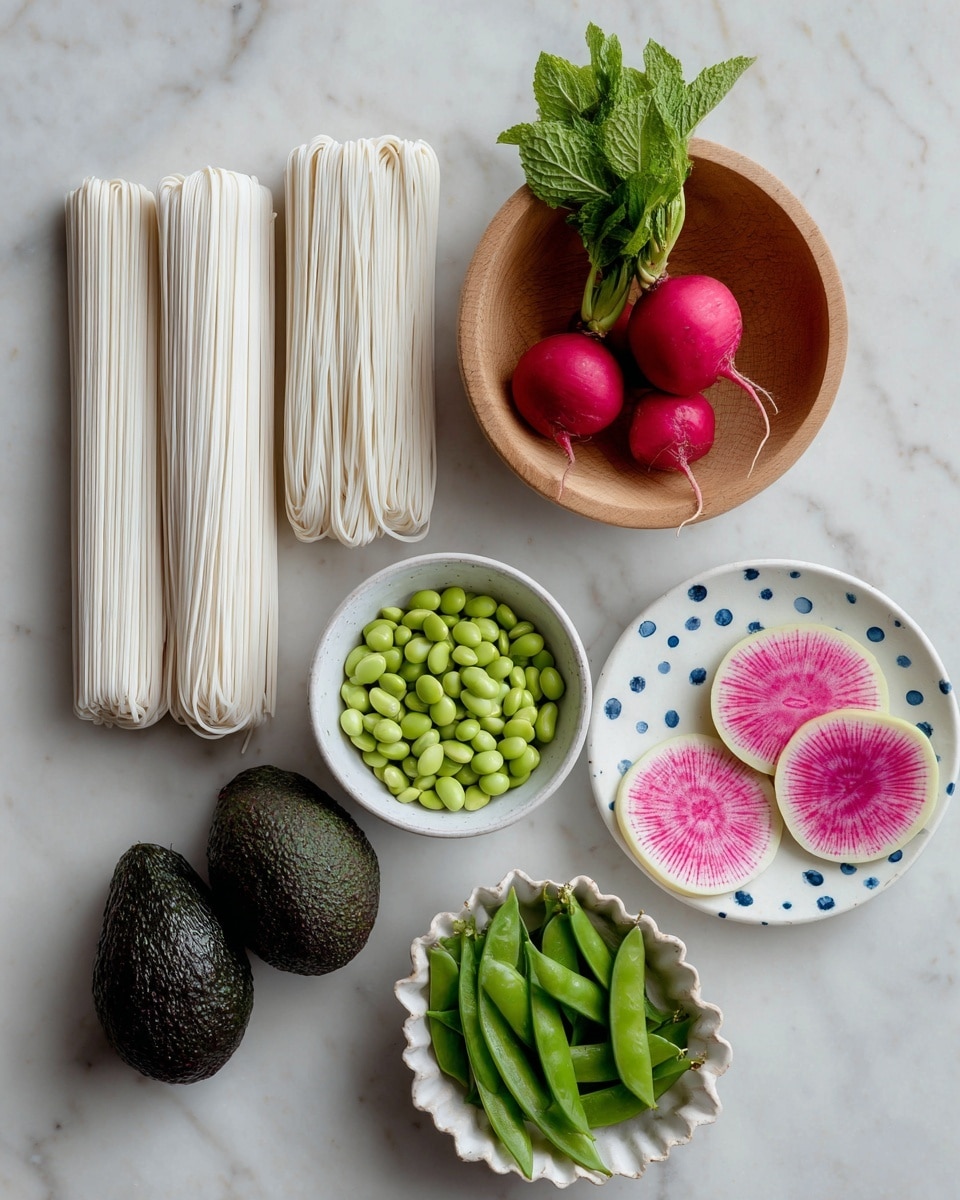 The image shows a neat arrangement of fresh ingredients on a white marbled surface. On the left side, there are two bundles of white noodles placed vertically. Below them is a small white bowl filled with green shelled edamame beans. To the right of the noodles and edamame, there are two dark green avocados lying side by side. Above them is a light wooden bowl holding four bright red radishes with small green stems. To the far right, two round slices of watermelon radish show a vibrant pink center with a pale outer edge, placed near a small white plate with blue dots around the edge holding fresh green mint leaves. At the bottom right corner is a small, scalloped white bowl filled with fresh green snap peas. photo taken with an iphone --ar 4:5 --v 7