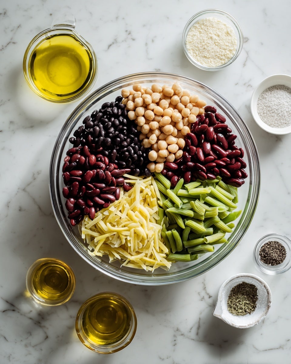 A clear glass bowl sits on a white marbled surface, filled with six separate piles of beans and vegetables arranged like slices of a pie. The piles include black beans, light beige chickpeas, dark red kidney beans, light green chopped celery, light yellow pasta sticks, and green beans, each with distinct colors and textures. Around the bowl, on the white marbled surface, are small clear and white containers holding yellow oil, light brown vinegar, white salt, black pepper, and a clear glass bowl with a white powder. Photo taken with an iphone --ar 4:5 --v 7