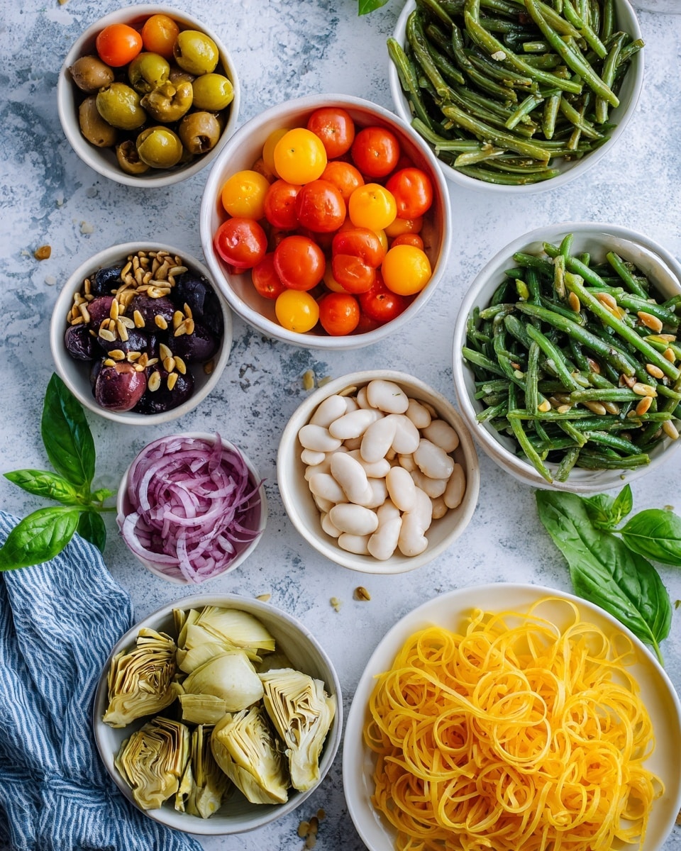 The image shows an overhead view of various white bowls and plates arranged on a white marbled textured surface with a blue and white cloth underneath. There are nine containers, each holding different ingredients: a white bowl with colorful halved cherry tomatoes in red, yellow, and orange at the top center; a white bowl with cooked green beans on the right; a small white bowl with sunflower seeds next to the green beans; a white bowl filled with white beans in the center; a white bowl with artichoke hearts below the beans; a small white bowl with thinly sliced red onions on the left; a white bowl with spiralized yellow squash noodles to the left center; a white bowl with dark olives above the tomatoes; and a white plate holding curly yellow pasta at the bottom right. Fresh green basil leaves and some parsley sprigs are placed on the cloth near the left side. The overall setup is bright and colorful with vibrant vegetables and pasta, emphasizing fresh ingredients. Photo taken with an iphone --ar 4:5 --v 7