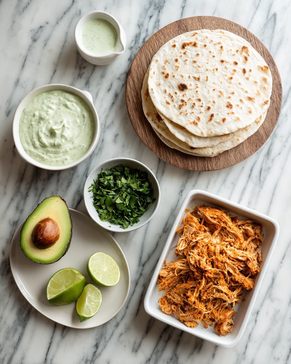 The image shows a top view of a meal setup on a white marbled surface. On the top right, there is a stack of white flatbreads on a round wooden board. Next to it on the left side is a small white bowl with a light green creamy sauce, and below it is a plate with half an avocado, showing its green and brown colors. Below that plate, there are lime wedges arranged on the surface. In the center, there is a small white bowl filled with chopped green herbs. To the right of the herbs, there is a white rectangular dish filled with shredded orange-colored cooked meat. The colors have a fresh and natural look with a mix of greens, browns, and light tones. photo taken with an iphone --ar 4:5 --v 7