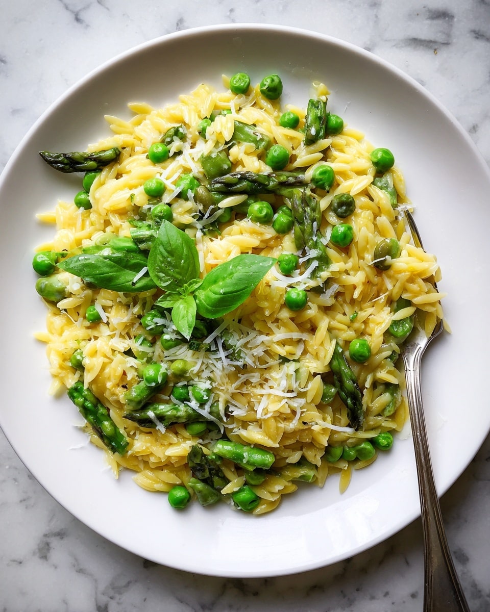 The image shows a white bowl filled with a fresh green vegetable mix, including whole green beans, asparagus spears, snap peas, and fresh mint leaves scattered on top. The vegetables are long and thin with smooth textures, creating a vibrant mix of different shades of green. To the side, there is a small bowl with light yellow shaved cheese, sitting on a white marbled surface. A gold salad serving spoon rests inside the bowl, partially visible among the vegetables, and a light blue cloth napkin is folded next to the bowl. The photo taken with an iphone --ar 4:5 --v 7