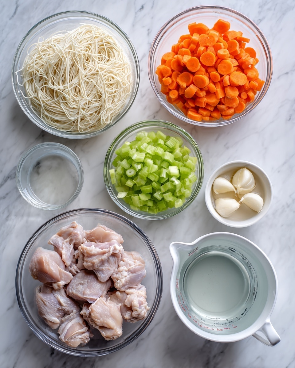 The image shows several clear glass bowls and a white measuring cup placed on a white marbled surface, containing different raw ingredients for cooking. There are five bowls: one filled with thin white noodles, another with sliced orange carrots, one with bright green sliced celery, a small bowl of two pale cloves of garlic, and a larger bowl holding raw chicken pieces with bones. The white measuring cup is filled with water. The items are arranged neatly, showing a clear view of each ingredient’s color and texture. Photo taken with an iphone --ar 4:5 --v 7