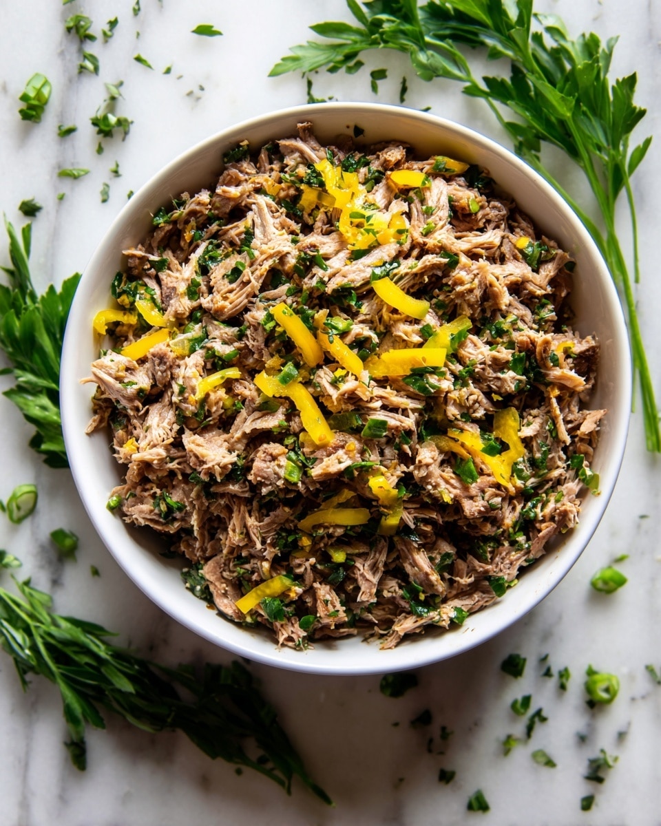A white bowl filled with shredded brown cooked meat spread evenly across the bowl. Bright yellow pepper pieces are placed on top and mixed in, adding a pop of color. Small bits of green herbs are sprinkled over the meat, giving a fresh look. The bowl is on a white marbled surface with a few green herbs and peppers scattered around. photo taken with an iphone --ar 4:5 --v 7