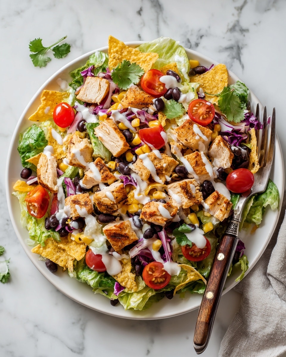 A white plate filled with a colorful salad sits on a white marbled surface. The salad has a base layer of torn green romaine leaves, topped with black beans scattered all over. Bright yellow corn kernels are mixed among the beans and greens. Cherry tomatoes, both whole and sliced in half, add a pop of red. Light brown grilled chicken pieces are spread across the top. Crushed yellow corn chips add texture, scattered between the other ingredients. Small bits of red onion add purple spots throughout. Fresh green cilantro leaves are visible on top. A light drizzle of creamy white dressing is spread over the salad. A silver fork with a wooden handle rests on the right side of the plate. Extra cherry tomatoes and cilantro are placed around the plate on the white marbled surface. photo taken with an iphone --ar 4:5 --v 7