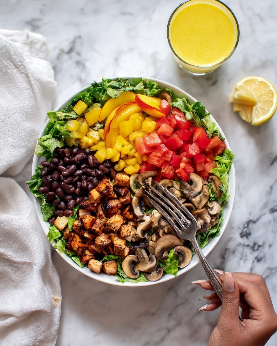 The image shows a white bowl filled with a colorful salad placed on a white marbled surface. The salad has five main layers starting with a base of green lettuce leaves at the bottom. On top of the lettuce, there are diced bright red tomatoes, sliced grilled brown mushrooms, black beans, and golden yellow peach slices arranged in separate sections around the bowl. A lemon wedge is placed on the side of the bowl, and a glass of yellow dressing sits nearby. The scene includes a woman's hand holding a fork and knife close to the bowl. Photo taken with an iphone --ar 4:5 --v 7