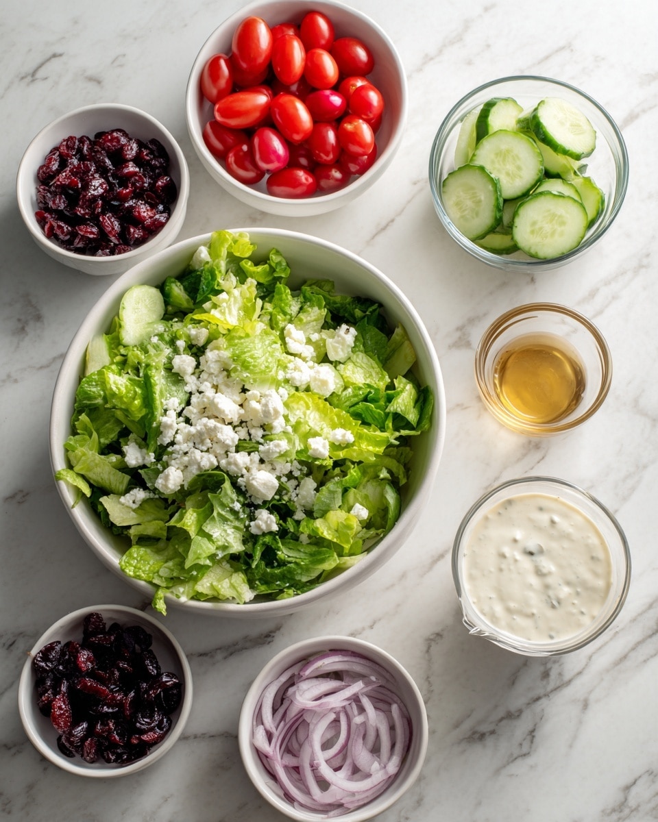 A set of six white bowls arranged on a white marbled surface, each containing fresh salad ingredients. The largest bowl is filled with green leafy lettuce topped with small white cheese crumbles. Surrounding it, five smaller bowls hold bright red cherry tomatoes, light green cucumber slices, thinly sliced light purple onions, dark red dried cranberries, and a small glass container of creamy white dressing. Two clear small bowls with golden and white liquids are also present. The overall scene has bright, fresh colors and a clean look. photo taken with an iphone --ar 4:5 --v 7