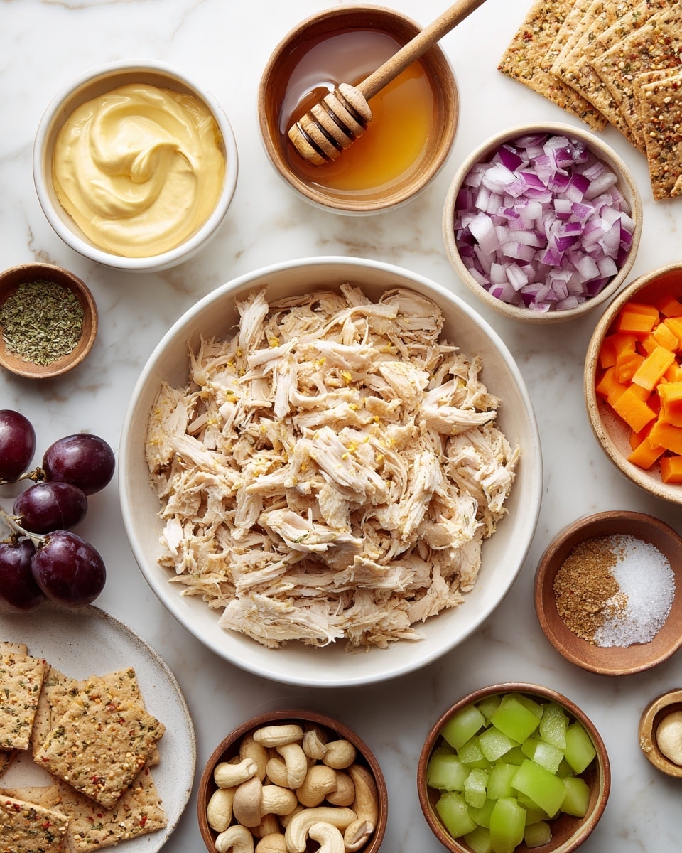 A top-down view of a white bowl filled with shredded light beige chicken in the center, surrounded by smaller bowls placed on a white marbled surface. Clockwise from the top left, there is a white bowl with thick pale yellow mayonnaise, a light brown bowl with amber honey and a wooden honey dipper, a light brown bowl with chopped purple and white onions, a small beige bowl with dried green herb, a brown bowl with light brown cashew nuts, a dark brown bowl with bright green diced celery, a white plate with several rectangular multigrain crackers, a few small dark purple grapes, a light brown bowl with smooth golden mustard, and a dark brown bowl with light orange shredded carrots. There are also small bowls with salt and pepper and garlic powder near the center. Photo taken with an iphone --ar 4:5 --v 7