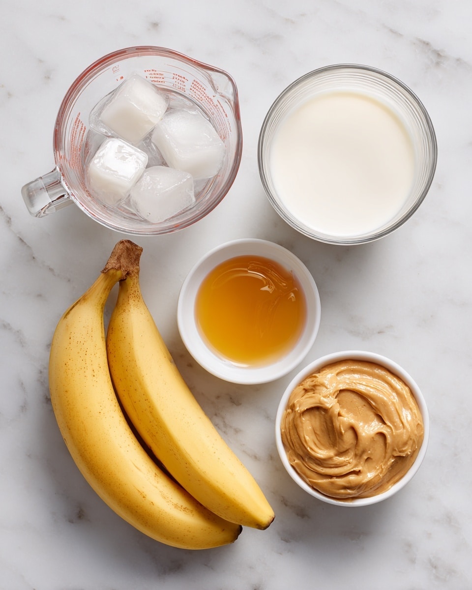 The image shows five separate ingredients placed on a white marbled surface: a clear glass measuring cup filled about halfway with ice cubes on the top left, a similar clear glass measuring cup nearly full with white milk to its right, two yellow bananas with slight brown marks on the far right, a small white bowl with smooth golden honey below the ice, and another small white bowl filled with creamy light brown peanut butter positioned to the right of the honey. photo taken with an iphone --ar 4:5 --v 7