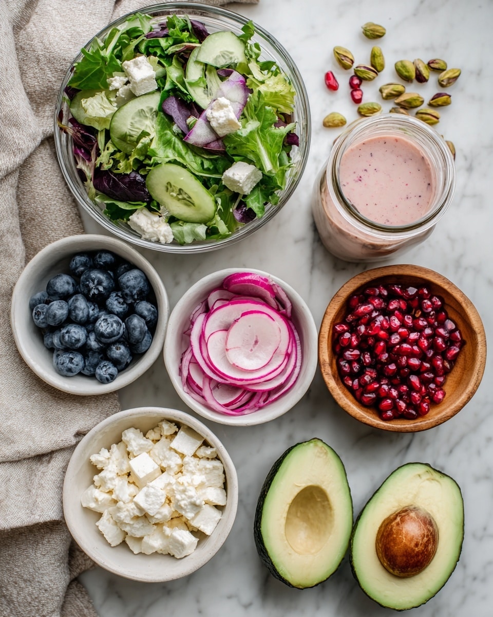 The image shows a top view of a white marbled surface with several bowls and food items arranged neatly. A large glass bowl filled with mixed green salad is at the top center. Below it, four smaller white bowls hold blueberries, bright pink and green radish slices, thin purple onion slices, and crumbly white cheese. To the right, there is a small wooden bowl filled with green pistachios. A halved avocado with its seed removed is placed on the white marbled surface near the bowls. Next to the avocado, there are bright red pomegranate seeds scattered slightly. A small glass jar filled with a pinkish dressing stands near the salad bowl. A woman’s hand is gently holding the jar, ready to pour. The whole scene looks fresh and colorful, with a soft towel placed under some items. photo taken with an iphone --ar 4:5 --v 7