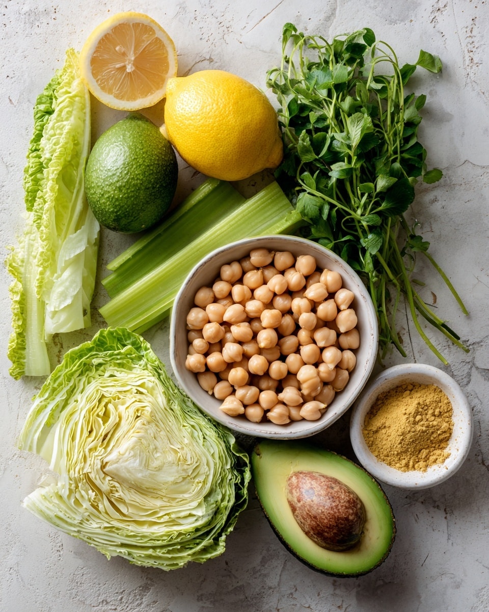 The image shows a variety of fresh ingredients neatly arranged on a white marbled surface. In the front, there is a white bowl full of round, light brown chickpeas. Behind the bowl, there is a bunch of fresh green herbs with fine leaves, and next to them, small green leaves spread across the surface. Near the top, a halved lemon with a bright yellow inside lies next to a smooth dark green avocado. To the left, light green celery stalks stand vertically beside a folded pale green cabbage leaf. In a small white bowl on the right, there is a pile of fine, yellow powder. The colors range from soft greens to yellows and browns, and the textures go from smooth and creamy to leafy and rough. photo taken with an iphone --ar 4:5 --v 7