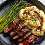 Pan-Seared Bavette Steak with Garlic-Parsley Butter, Crispy Potatoes, and Asparagus Recipe