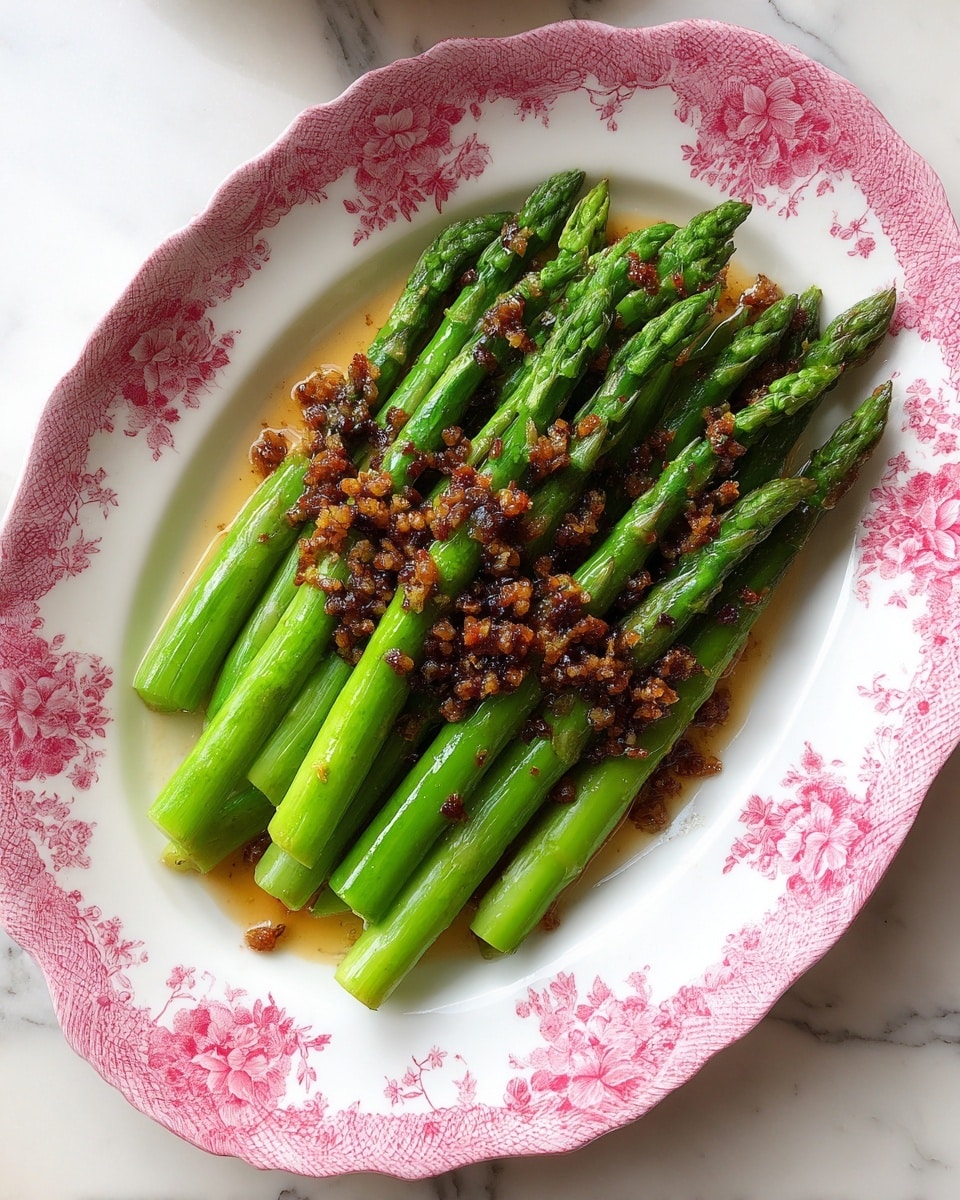 A white oval plate holds a neat pile of green asparagus with slightly brown-tipped ends, arranged with their spears pointing in the same direction. Around the plate on a white marbled surface are small clear bowls containing light yellow butter cubes, minced garlic, finely grated cheese, salt, black pepper, and a small glass bowl of golden olive oil. A whole bright yellow lemon is placed near the bowls, adding a pop of color. The scene is bright and clean with natural lighting. photo taken with an iphone --ar 4:5 --v 7