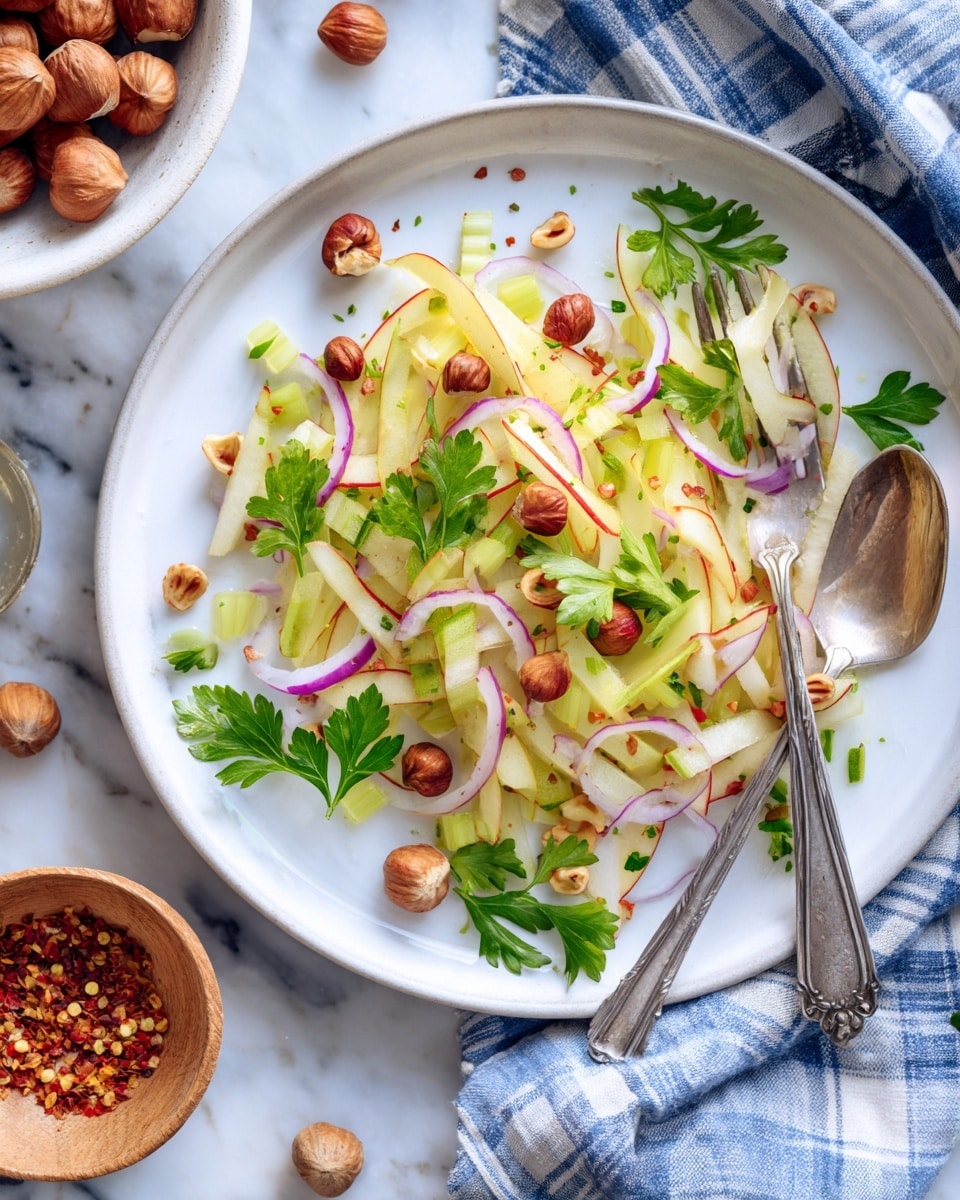 A white plate with a beige rim holds a fresh salad made of thin light green and red sticks, thin light purple slices, and round brown nuts scattered on top, mixed with small green leaf sprigs. A silver spoon and fork rest on the right side of the plate, with a piece of the red and white ingredient on the spoon. The plate is placed on a white marbled surface, with a white bowl filled with more brown nuts visible at the top left and a checkered cloth near the top right. photo taken with an iphone --ar 4:5 --v 7