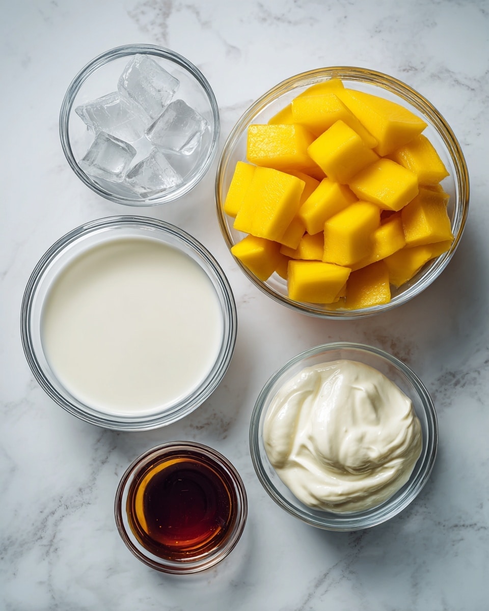 The image shows five clear glass bowls arranged on a white marbled surface. The largest bowl is filled with bright yellow mango cubes, showing a smooth yet slightly fibrous texture. Next to it, a medium bowl contains white milk with a creamy, smooth surface. Above that, a smaller bowl holds three ice cubes, clear and slightly frosty, with sharp edges. Another small bowl is filled with thick white yogurt, showing a slightly uneven and creamy texture. The last bowl is the smallest and contains a dark amber liquid with a shiny, smooth surface. All bowls are simple and transparent, highlighting the different colors and textures of their contents. Photo taken with an iphone --ar 4:5 --v 7