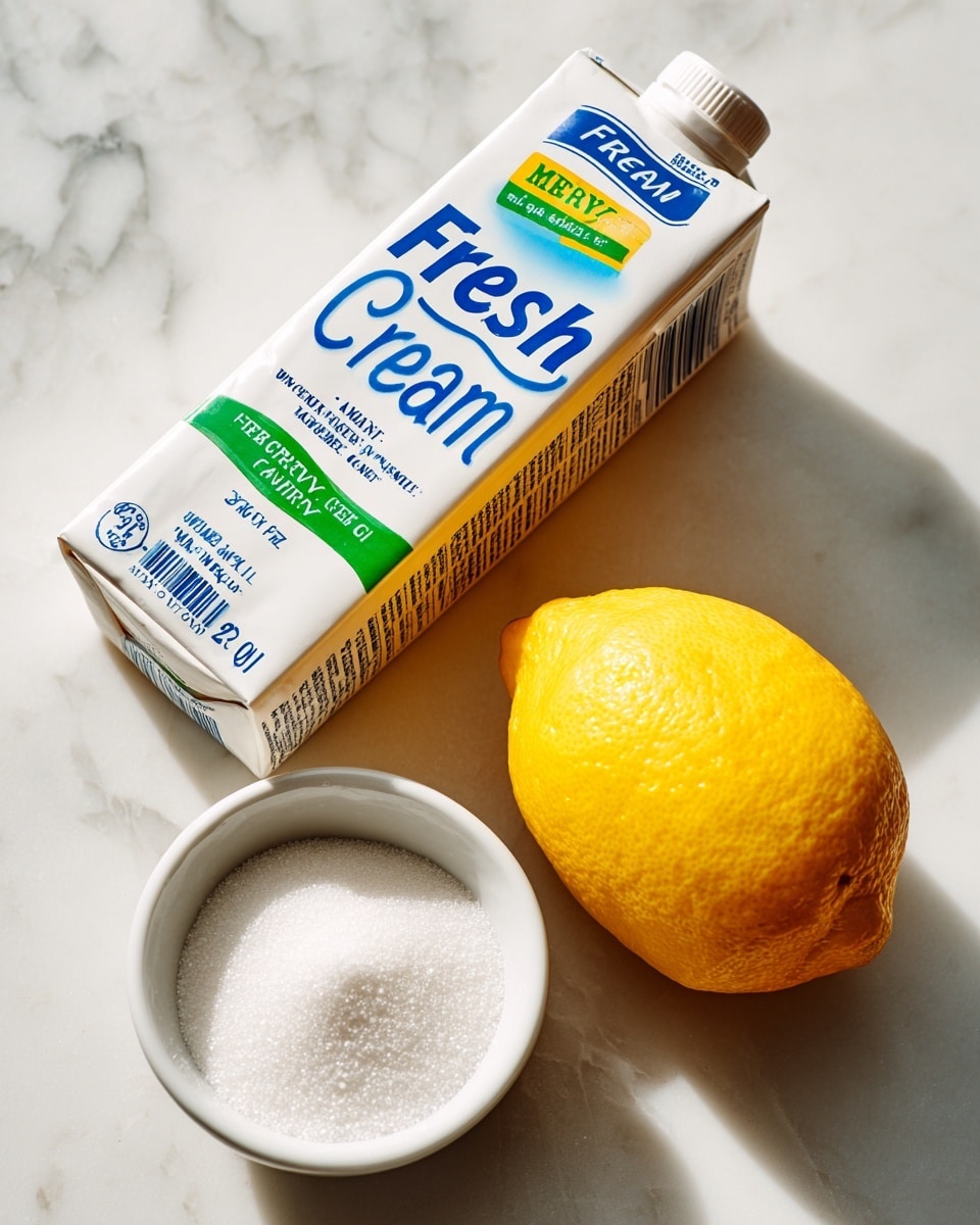 A white carton of heavy cream with blue and green text lies angled on a white marbled surface, showing labels like