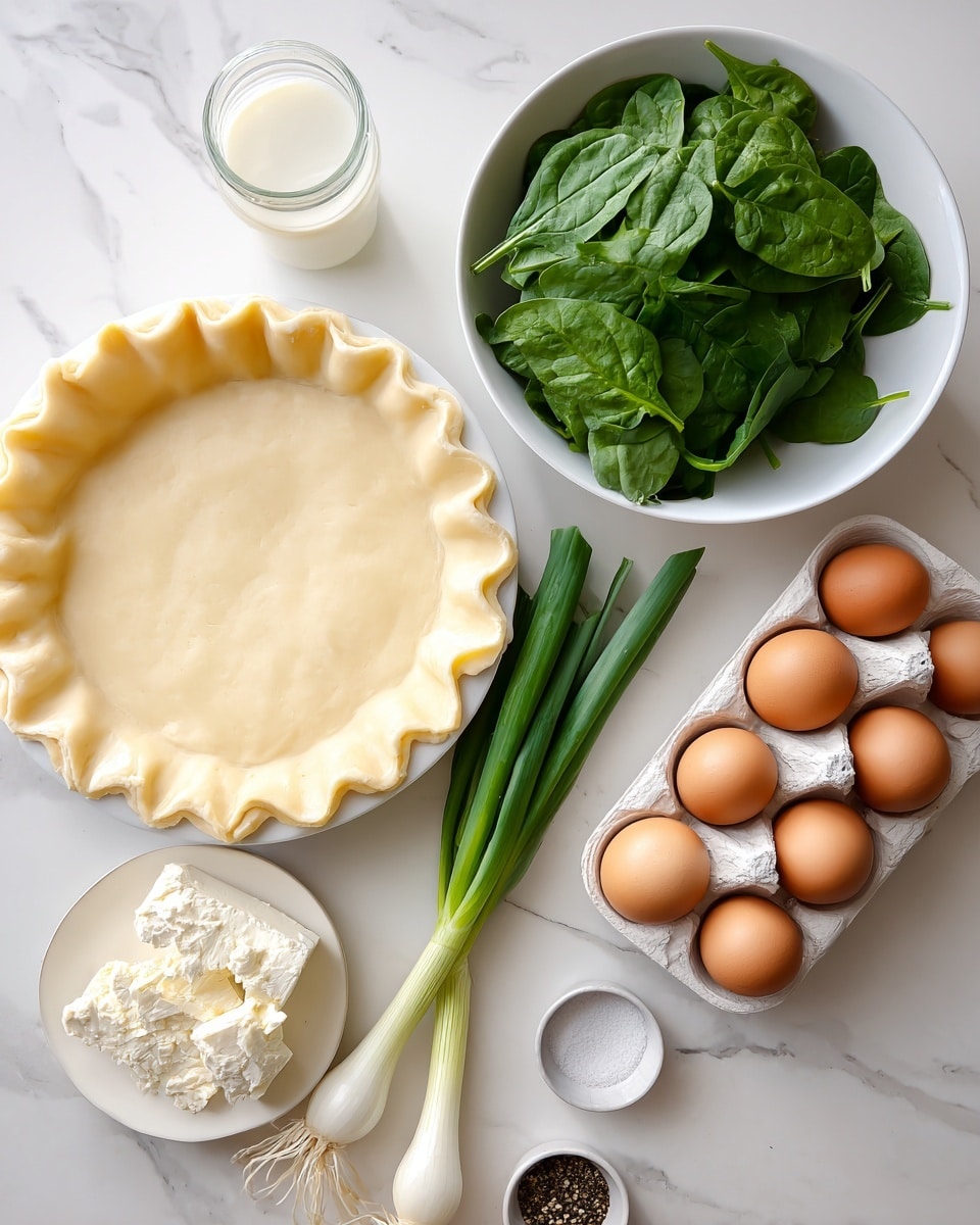 The image shows a pie crust with a crimped edge in a white pie dish on the left side, with a smooth pale yellow color and soft texture. Next to it, a white bowl filled with fresh green spinach leaves with a shiny, crisp texture sits on a white marbled surface. Below the spinach, there are fresh green onions with white bulbs and long green stalks spread out. To the bottom left, a small plate holds a block of white crumbly cheese. Near the onions, there is a clear small jar of white liquid, possibly milk or cream. On the right side, a white egg tray holds six brown eggs with smooth shells. At the bottom right, a tiny white dish contains ground black pepper. All items are arranged neatly on a white marbled background. photo taken with an iphone --ar 4:5 --v 7