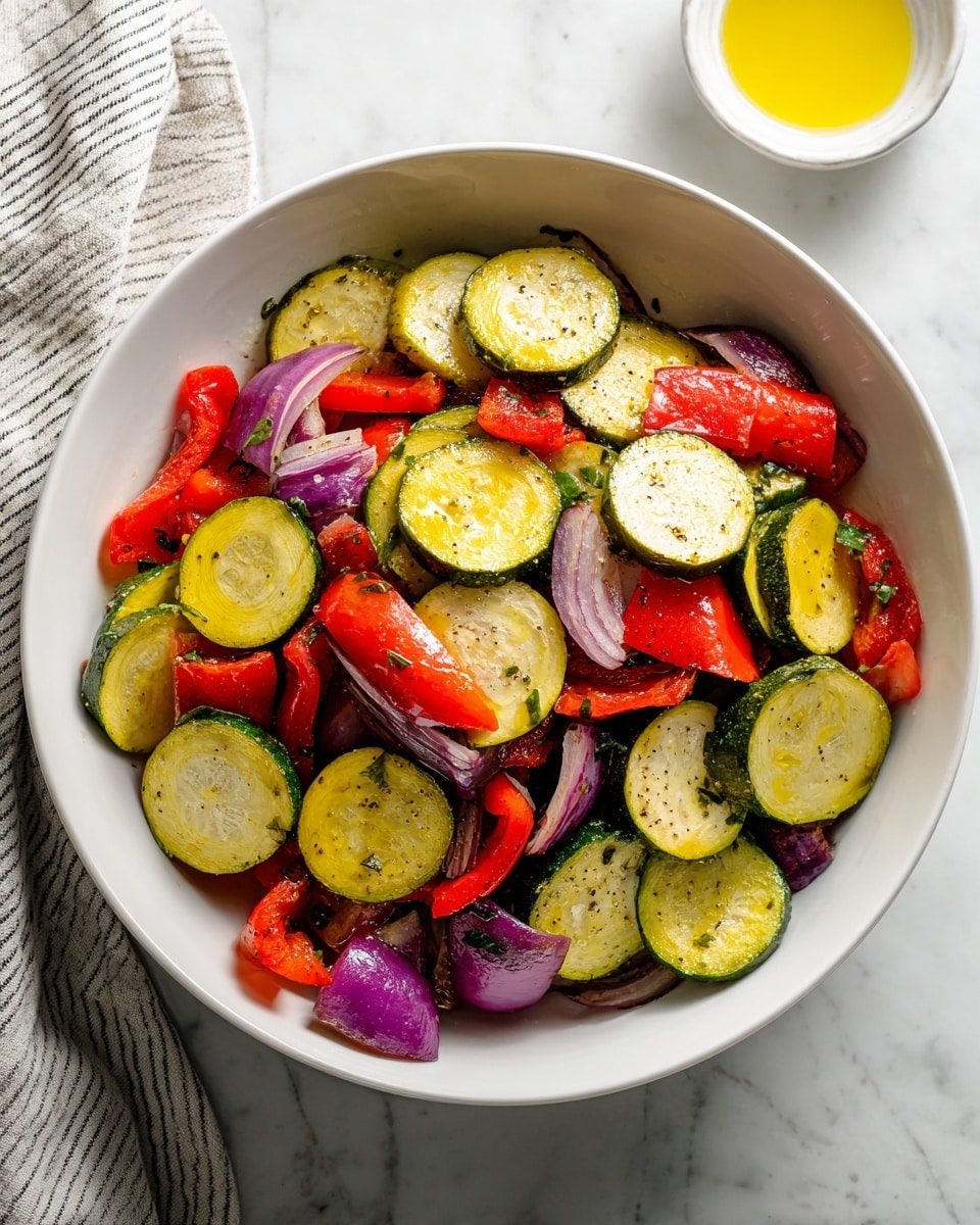 A white bowl on a white marbled surface filled with thick round slices of yellow squash and green zucchini, mixed with large chunks of red bell pepper and pieces of purple onion. The vegetables are raw with fresh and firm textures, layered in a loose pile inside the bowl. To the right, a portion of a white bowl with yellow oil is visible, and to the left, part of a striped cloth rests on the surface. Photo taken with an iphone --ar 4:5 --v 7