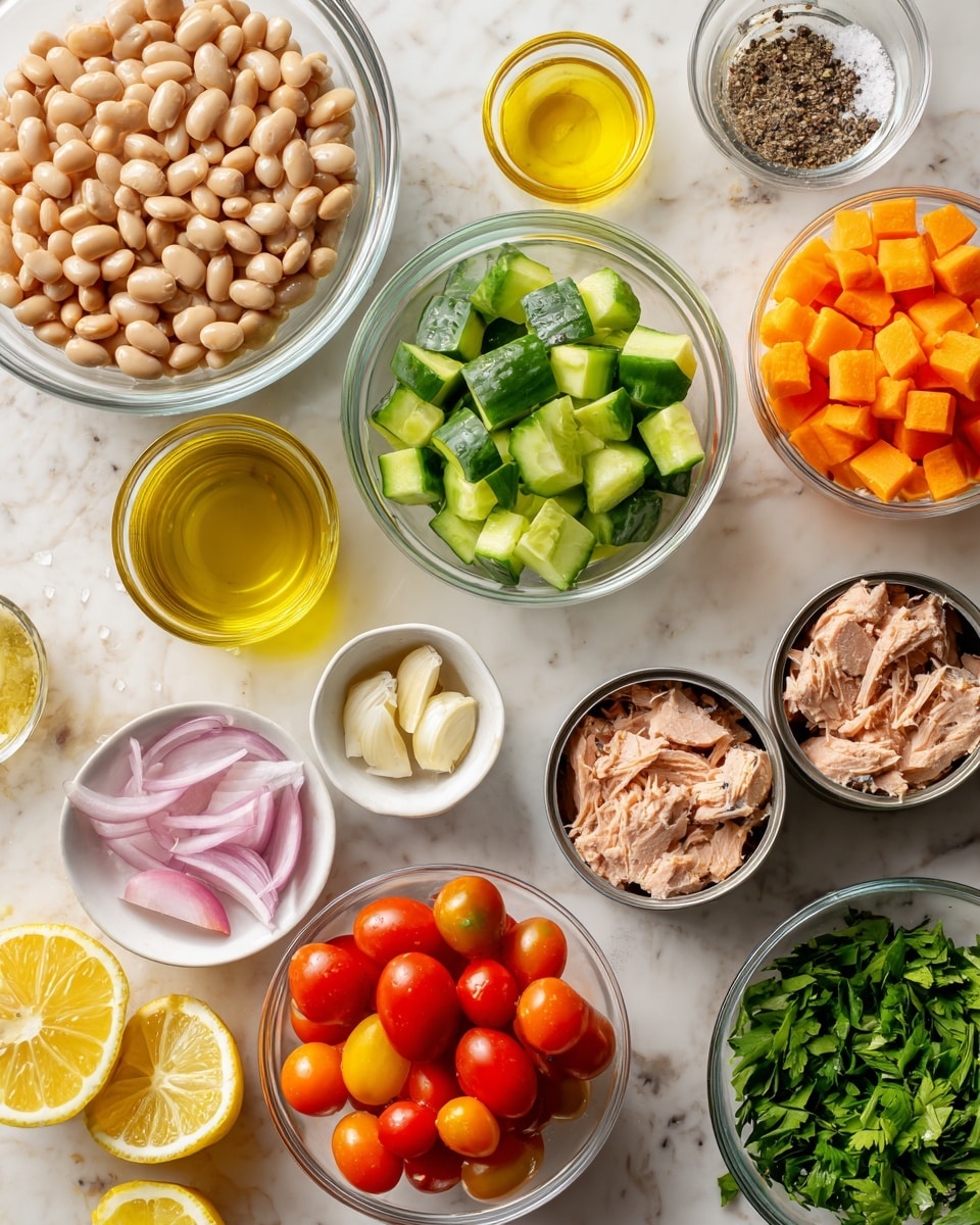 A top view shows many glass bowls on a white marbled surface, each with different ingredients. The largest bowl on the left has light beige beans with a smooth surface. To the right of it, a medium bowl holds chopped green cucumber pieces with a shiny, wet texture. Below that, a small bowl contains thin white and pink slices of shallots. Next to that, two open cans reveal light brown tuna with a soft, flaky texture. Another medium bowl is filled with bright red cherry tomatoes, some whole and some cut in half showing juicy interiors. Near the tomatoes, a small bowl has a bright yellow mustard. Above the cucumbers, a small bowl has a golden yellow liquid, likely oil. A very small bowl with minced garlic is visible near the beans. Two lemon halves with bright yellow rind and pale yellow inside lie on the surface. Another small bowl contains diced bright orange carrots while a third bowl holds fresh green chopped herbs. A small white bowl in the top right holds salt and black pepper. Everything is neatly placed on the white marbled surface creating a fresh and clean look photo taken with an iphone --ar 4:5 --v 7