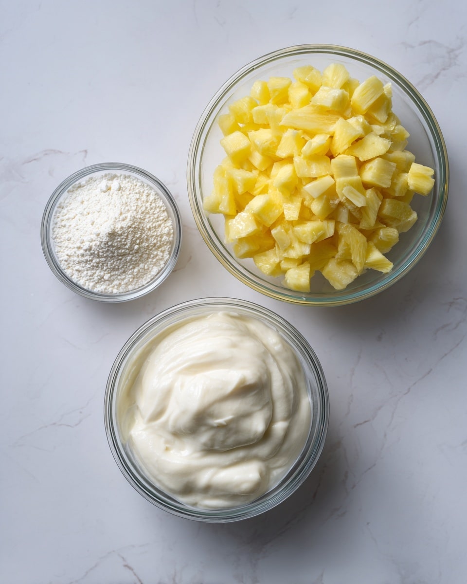 The image shows three clear glass bowls on a white marbled surface. The largest bowl is filled with small, diced yellow pieces that look soft and fresh, sitting on the right side. Below it, a medium-sized bowl holds a thick white creamy substance with a smooth texture. Above and slightly to the left of the large bowl, there is a small bowl containing a white powdery material with a fine texture. The bowls are arranged close together, creating a simple and clean composition. Photo taken with an iphone --ar 4:5 --v 7