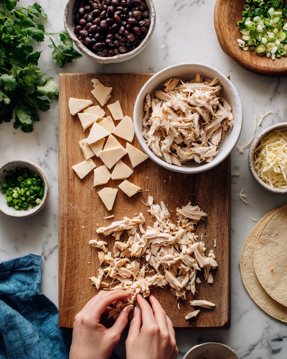 A wooden board lies on a white marbled surface, holding various ingredients in white bowls and scattered on the board. At the top center, there is a white bowl with several light brown triangular pieces that have a smooth texture. To the right, a white bowl holds shredded light beige cooked chicken pieces. Below the bowls on the board, there are small piles of shredded chicken pieces. A woman's hands are shown working with shredded chicken near the bottom of the image. Surrounding the board, there is a handful of fresh green cilantro on a blue cloth near the bottom left, a small white bowl with chopped green onions near the top left, a bowl with dark mashed beans, and a small wooden plate with shredded cheese. A folded tortilla is partly visible on the right side of the image. The photo taken with an iphone --ar 4:5 --v 7