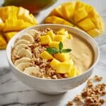 Refreshing Mango Smoothie Bowl with Granola and Tropical Toppings Recipe