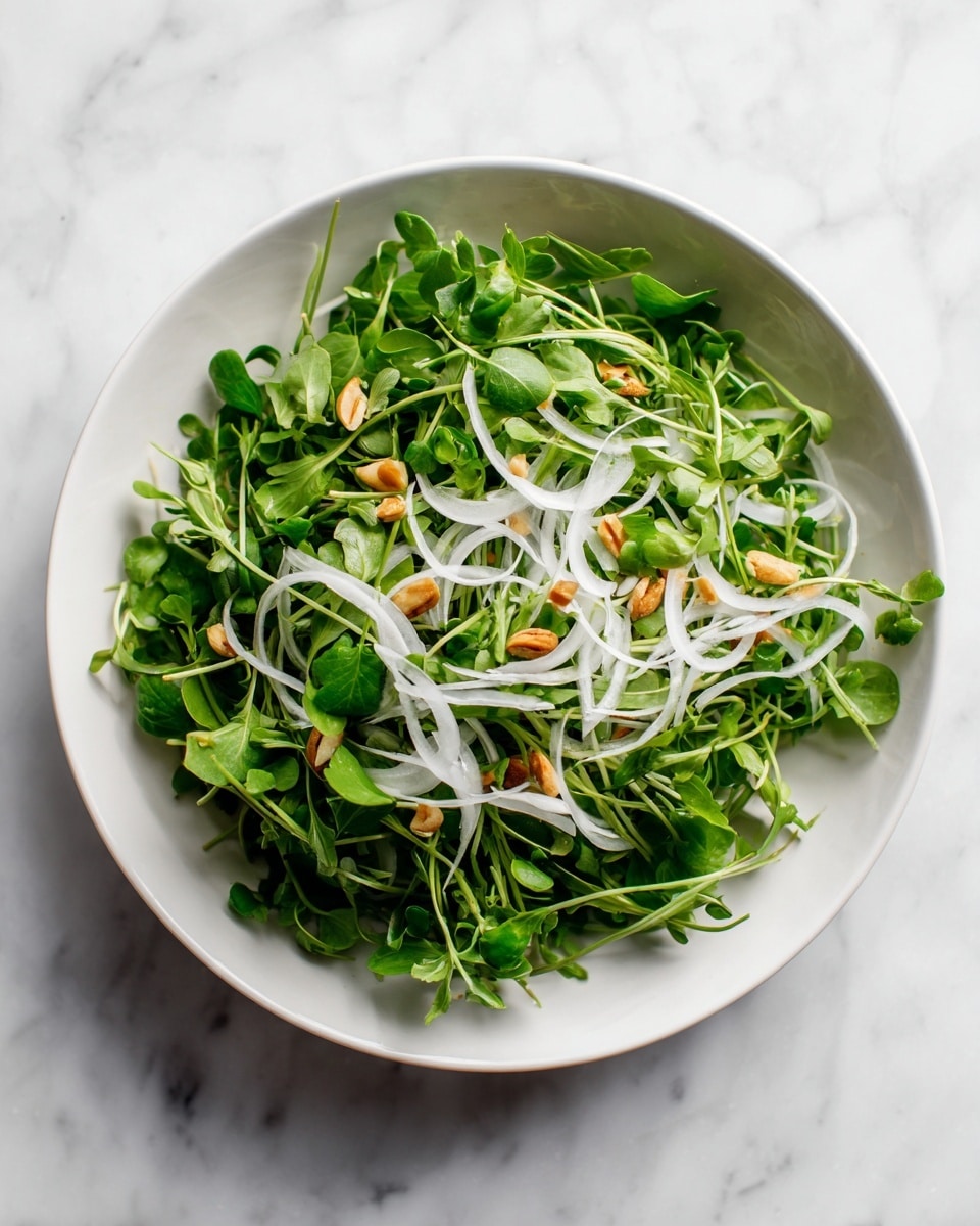 The dish is served in a white bowl with a slightly rough texture. It has three main layers: the bottom layer is fresh green spinach leaves that look soft and fresh, the middle layer consists of thin, pale slices of pear placed evenly over the spinach, and the top layer is made up of small, light brown walnut pieces scattered across the pears. There are small bits of white cheese crumbled over the entire dish, adding a creamy texture contrast. The bowl sits on a white marbled surface. Photo taken with an iphone --ar 4:5 --v 7