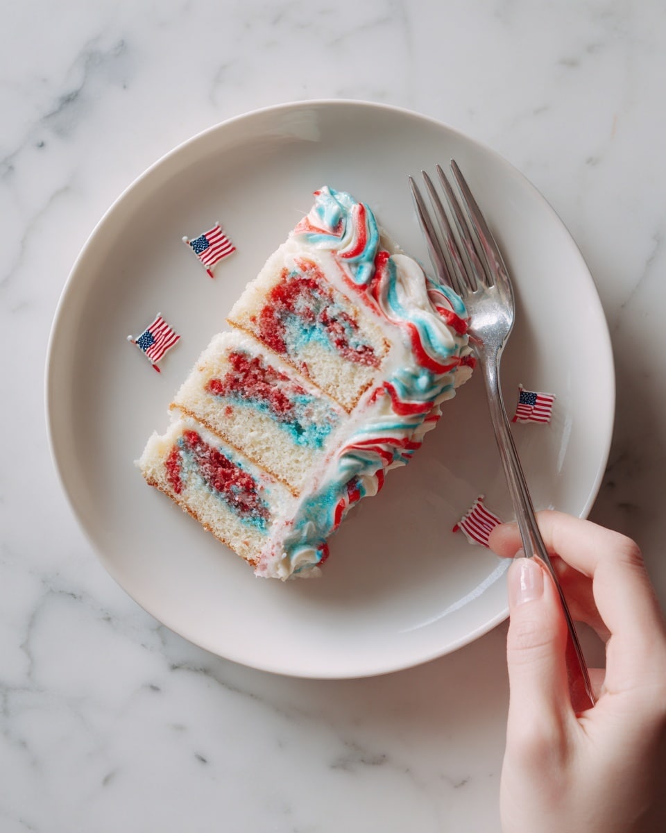 The image shows a slice of cake on a white plate placed on a white marbled surface. The cake has three visible layers inside, with a mix of red, blue, and white colors swirled through each layer, creating a bright and playful pattern. The outer layer of the cake is covered with white icing, topped with red and blue decoration icing in wavy lines. There is a fork next to the cake on the plate, and small paper American flags are placed around the plate on the surface. A woman's hand is about to reach for the fork. Photo taken with an iphone --ar 4:5 --v 7